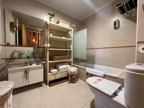 a bathroom with a sink and a toilet and a tub at A. Rural LA COVATILLA en Navacarros in Navacarros