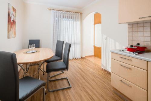 a small kitchen with a table and chairs in a room at Hotel Lorenz in Bad Füssing