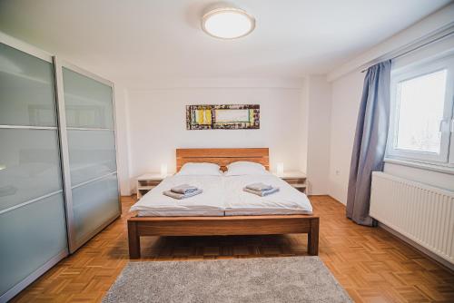 a bedroom with a bed and a large window at Apartment pri Povhih in Slovenske Konjice
