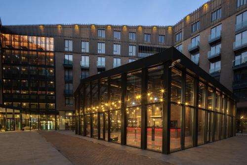 a large glass building in front of a building at Dedeman Kartepe Kocaeli in Kocaeli
