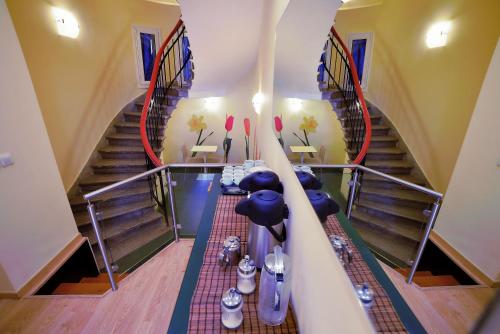a room with a staircase and a table with chairs at Orestias Kastorias in Thessaloniki