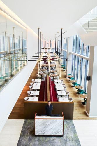 a man sitting at a desk in a large room with tables at Hyatt Regency Manchester in Manchester