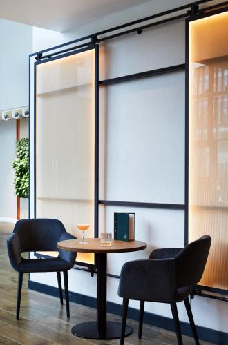a table and chairs in a room with windows at Hyatt Regency Manchester in Manchester