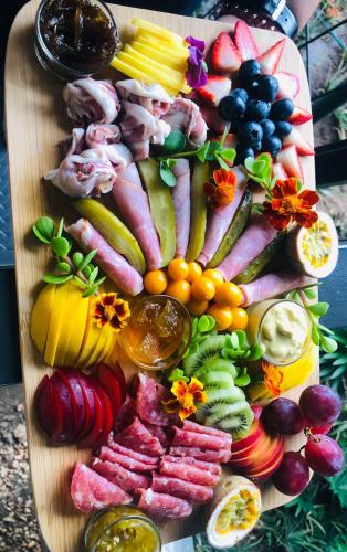 a cutting board filled with different types of fruits and vegetables at Aerotel in Hoedspruit