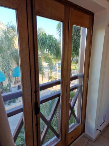 a door leading to a balcony with palm trees at Y & P LATCHI HOTEL in Lachi