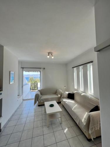 a living room with a couch and a table at Alepochori Seaside Village in Kato Alepochori