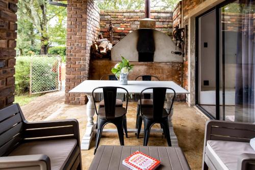an outdoor patio with a table and chairs and an oven at Belvidere Country Estate in Karkloof Nature Reserve