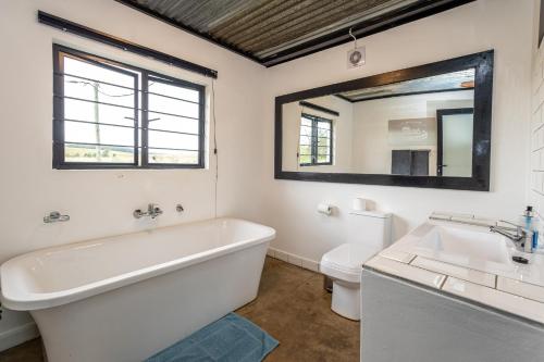 a bathroom with a tub and a sink and a toilet at Belvidere Country Estate in Karkloof Nature Reserve