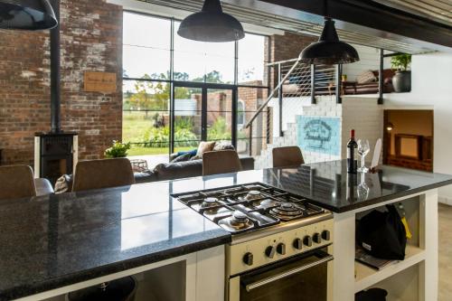 a kitchen with a stove top oven in a room at Belvidere Country Estate in Karkloof Nature Reserve