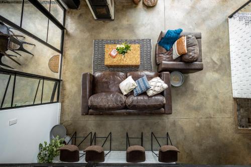 an overhead view of a living room with two leather couches at Belvidere Country Estate in Karkloof Nature Reserve