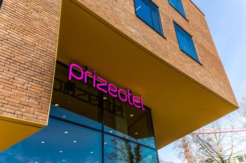 an office building with a neon sign on it at Prize by Radisson, Bonn City in Bonn
