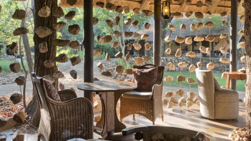 a room with chairs and a table and a window at Motswari Private Game Reserve by NEWMARK in Timbavati Game Reserve