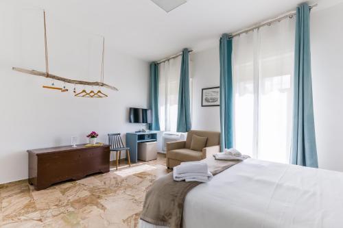 a bedroom with a bed and a chair and a desk at Scicli Albergo Diffuso in Scicli