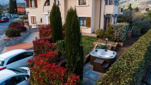 a house with cars parked in a parking lot at La Gardenia in Montecatini Terme