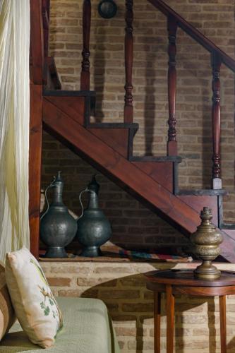 a wooden staircase with three vases on a table at Casa Di Veneto in Hersonissos