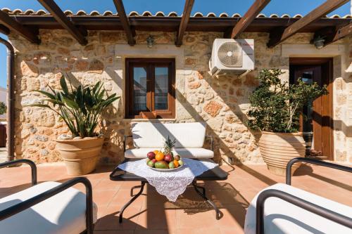 a patio with a table with a bowl of fruit on it at Casa Di Veneto in Hersonissos