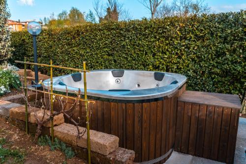 a bath tub in a garden next to a hedge at La Gardenia in Montecatini Terme