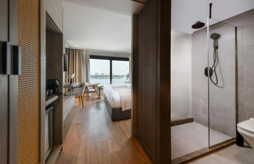 a hotel room with a bathroom with a bed and a shower at Historia The Boutique Hotel Nile Cruise - Every Monday from Luxor for 04 & 07 Nights - Every Friday From Aswan for 03 & 07 Nights in Luxor