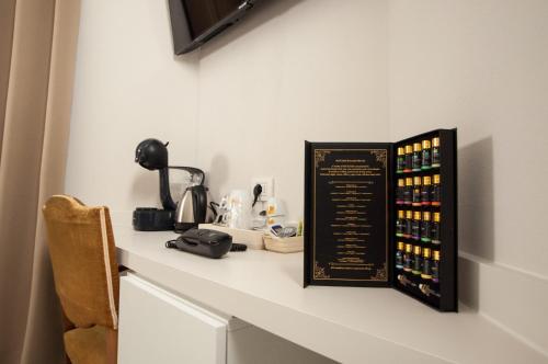 a counter with a sign on a wall with bottles of wine at Hotel Ca' di Gali in Sasso Marconi