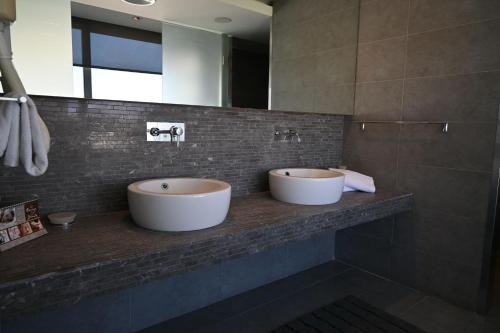two sinks on a counter in a bathroom at Angela Downtown Hotel in Rhodes Town