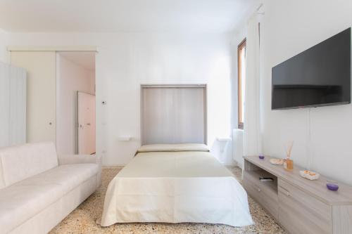 a white room with a bed and a couch at Canaletto Apartments in Venice