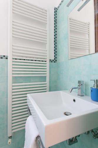 a white sink in a bathroom with blue tiles at Canaletto Apartments in Venice