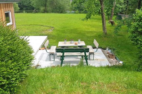a picnic table and chairs on a patio in a yard at Landhaus HALLSTATT FEELING - Apartment - Self Check-in in Bad Goisern