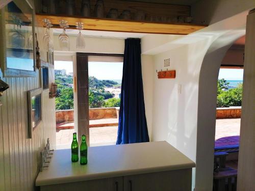 a kitchen with two bottles on a counter with a window at Claridges 104 in Margate