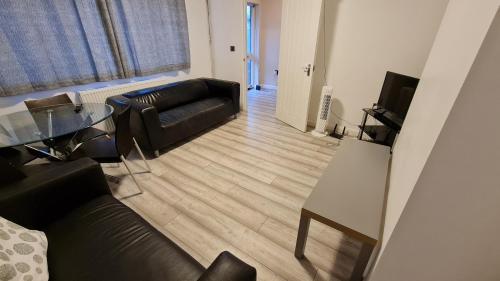 a living room with a couch and a table at Dartford Kent House - Hosted by Castile Accommodations Ltd in Kent