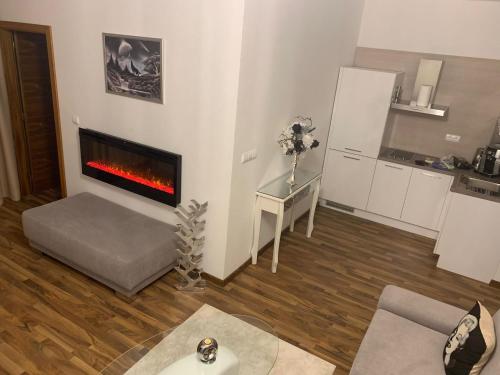 a living room with a fireplace in the wall at Oliver apartmán 6 in Vysoke Tatry - Strbske Pleso