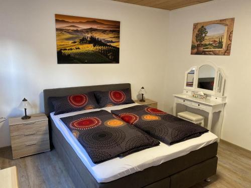 a bedroom with a bed with a painting on the wall at Ferienhaus Wolle & Beate in Alken