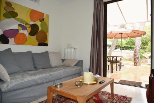 a living room with a couch and a table at Amazing Garden House in Athens