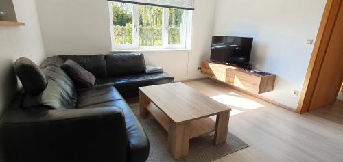 a living room with a couch and a coffee table at FN City Bungalow in Friedrichshafen