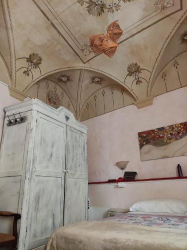 a bedroom with a bed and a ceiling with butterflies at Hotel Glicine in Noli