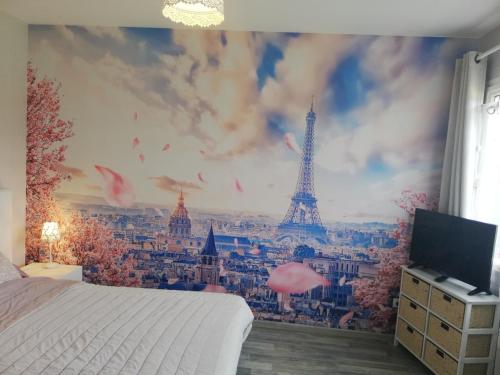 a bedroom with a mural of the eiffel tower at Le Clos du Chêne in Langon