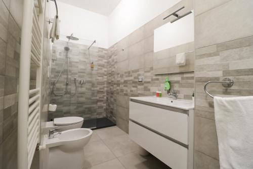 a bathroom with a toilet sink and a shower at Virtus Prestige - Rooms & Apartments in Rome