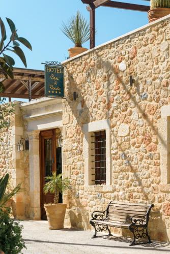 a bench in front of a building with a sign at Casa Di Veneto in Hersonissos