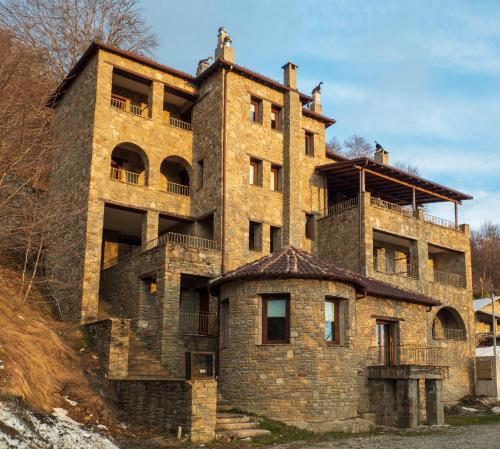 an old brick building on the side of a hill at Boutique Luxury Chalet 1450 in Kastoria