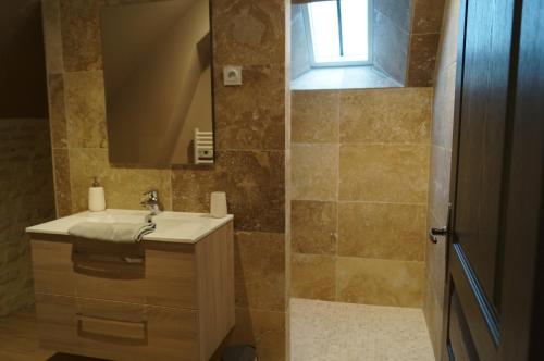 a bathroom with a sink and a mirror at l'atelier spa in Bayeux