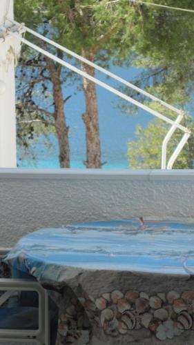 a person swimming in a swimming pool with trees in the background at Tatsis Apartments in Masouri