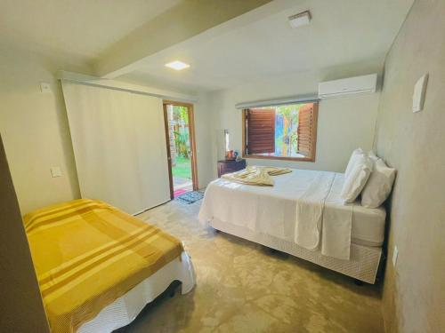 Un pat sau paturi într-o cameră la Pousada Jaboticaba Caraíva