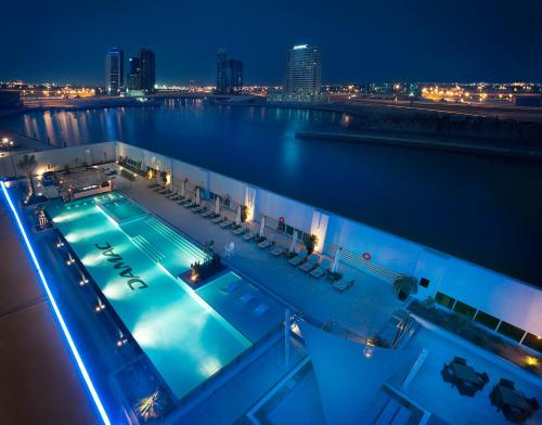 a swimming pool on a cruise ship at night at DAMAC Maison Canal Views in Dubai
