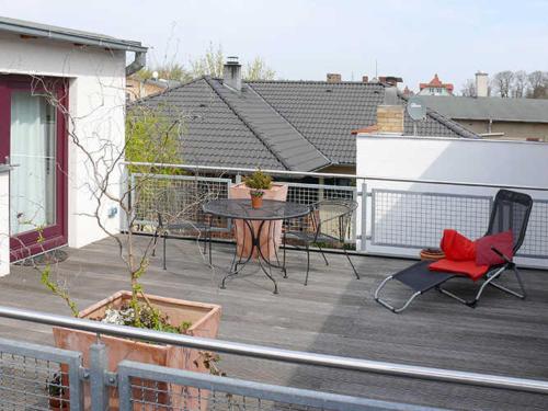 a patio with a table and chairs on a balcony at Ferienwohnungen "Vieling" Objekt-ID 12155 in Waren