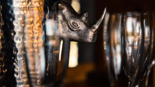 a group of glasses with a bronze star on them at Geiger's Camp in Timbavati Game Reserve by NEWMARK in Timbavati Game Reserve