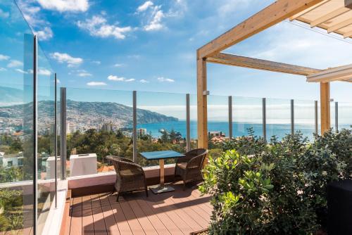 a view from the balcony of a house with a table and chairs at TUI Blue Gardens - Adults-only - Savoy Signature in Funchal