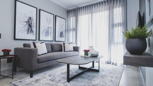 a living room with a couch and a table at The Catalyst Apartment Hotel by NEWMARK in Johannesburg