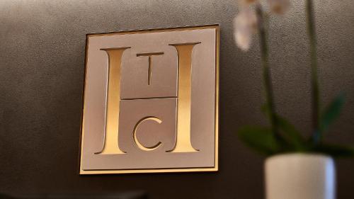 a sign on a wall with a vase of flowers at The Catalyst Apartment Hotel by NEWMARK in Johannesburg