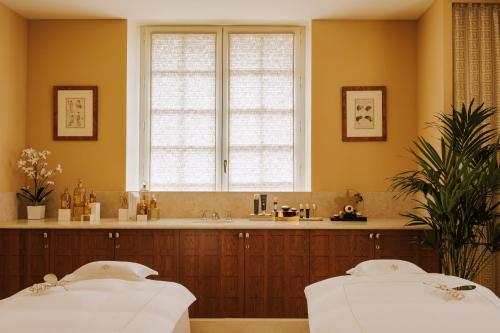 a bathroom with a large window and a large bed at Saint James Paris in Paris