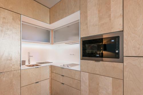 a kitchen with a microwave and a sink at Marques Design Apartments in Porto