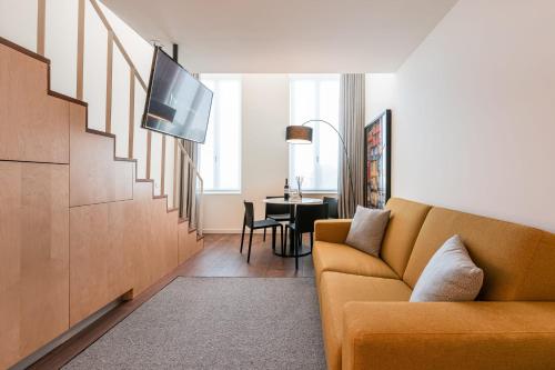 a living room with a couch and a table at Marques Design Apartments in Porto